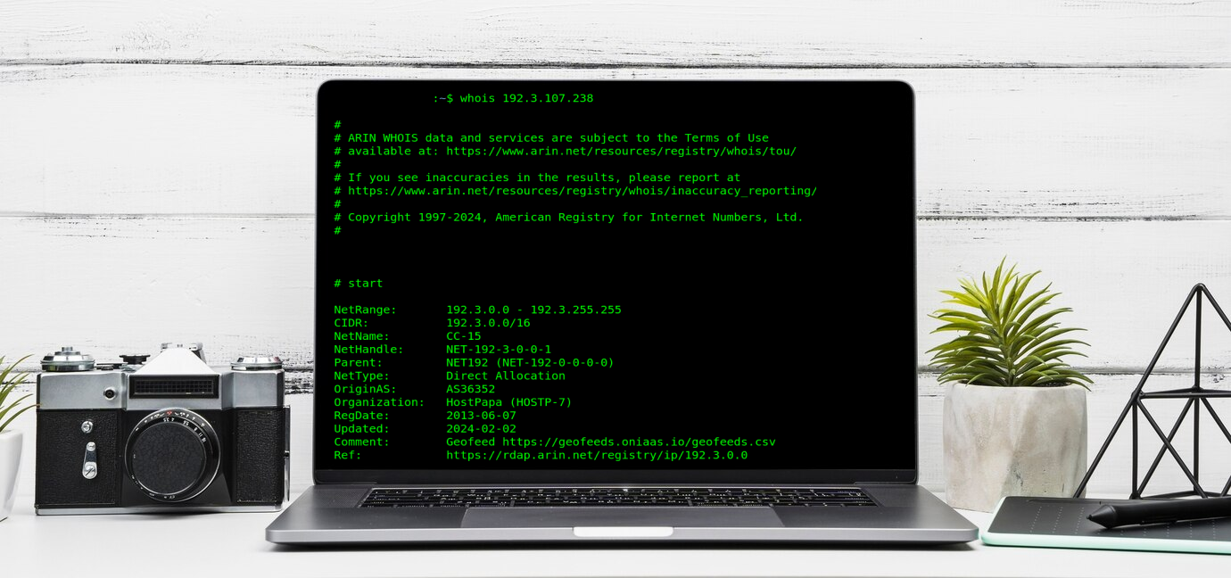 whois lookup on a laptop in front of white wall